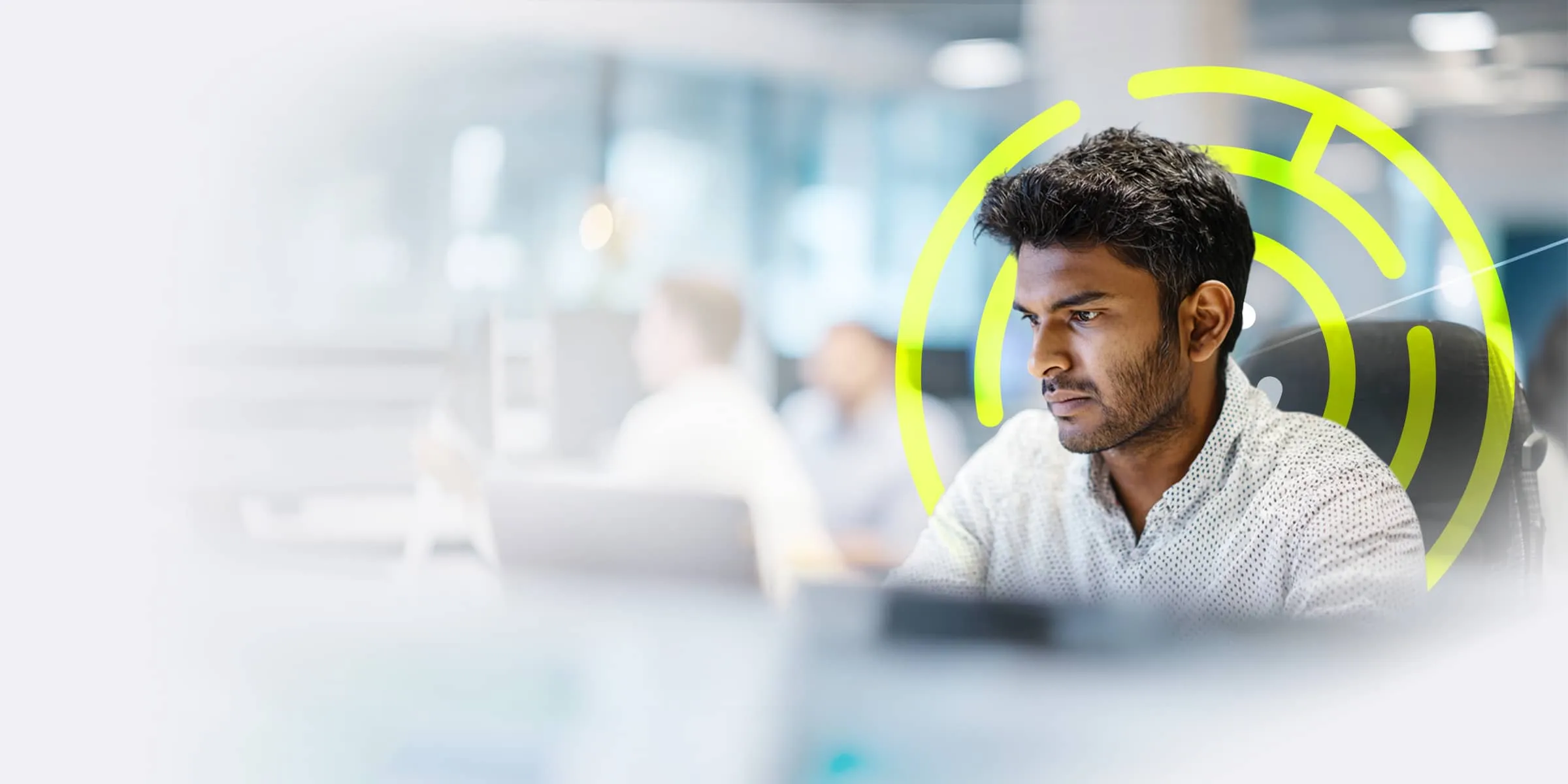 concentrating man working on a computer in a modern office